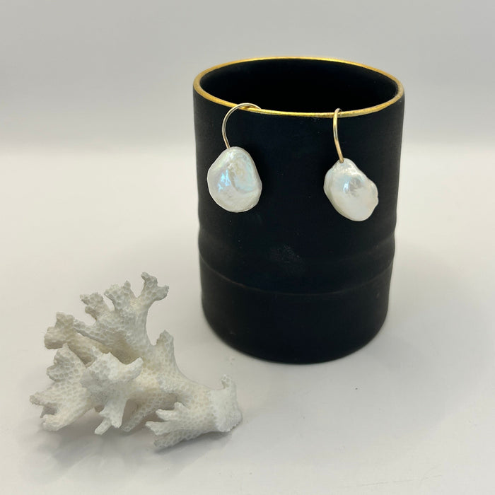 Baroque pearl hook earrings  against Fliff Carr ceramics